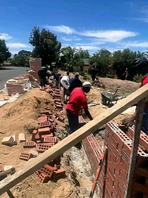 TMS bricklaying team building a wall on site