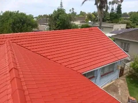 Tile roof restored and repainted in deep red