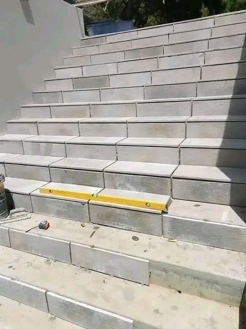 Spirit level checking newly laid concrete steps